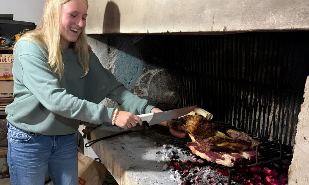 Select High School Exchange in Argentina, girl making asado